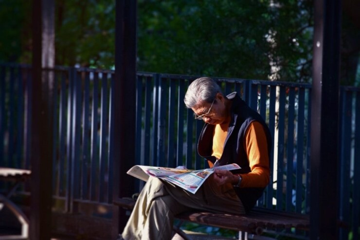 Elderly folk reading Sunday paper
