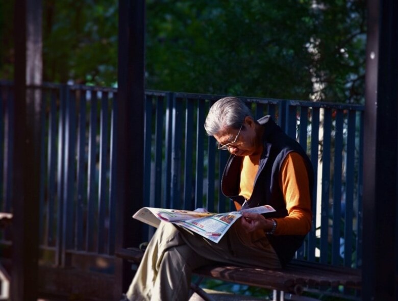 Elderly folk reading Sunday paper