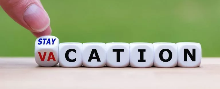 set of dices forming staycation word