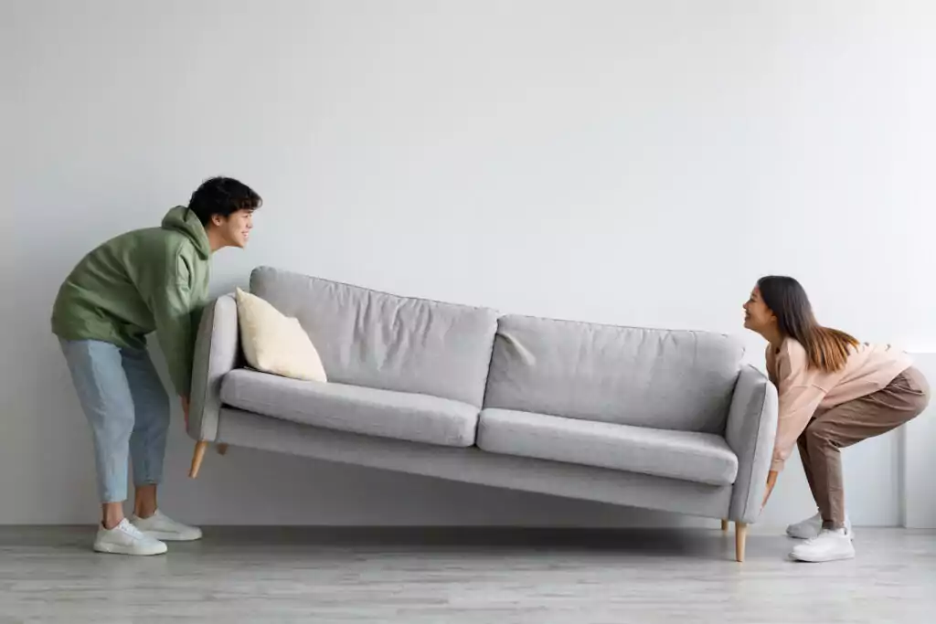 happy young asian couple moving sofa in living roo 2022 12 16 08 44 59 utc